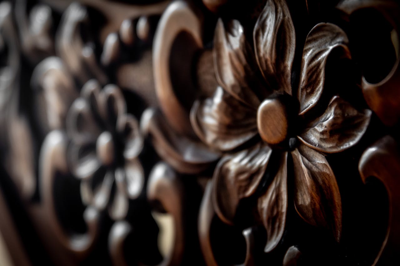 Detailed close-up of an intricately carved wooden floral pattern showcasing texture and craftsmanship.